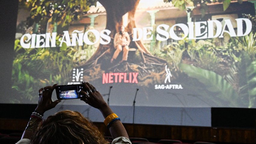 A Cuban woman takes a picture of the screen before the start of the screening of the TV series ‘One Hundred Years of Solitude,’ inspired by the novel by Colombian writer Gabriel García Márquez and brought to the screen by Netflix during the 45th International Latin American Film Festival at the Yara Theatre in Havana on December 6, 2024. . Netflix breaks into magical realism with the presentation in Cuba on Friday of the series ‘One Hundred Years of Solitude,’ in a country where access to this platform is complex. The first two chapters of the long-awaited series were presented as part of the New Latin American Film Festival in Havana, a celebration of celluloid in which Colombian Gabriel García Márquez (1927-2014), Nobel laureate and author of the celebrated novel, played a key role. (Photo by Yamil LAGE / AFP) (Photo by YAMIL LAGE/AFP via Getty Images)