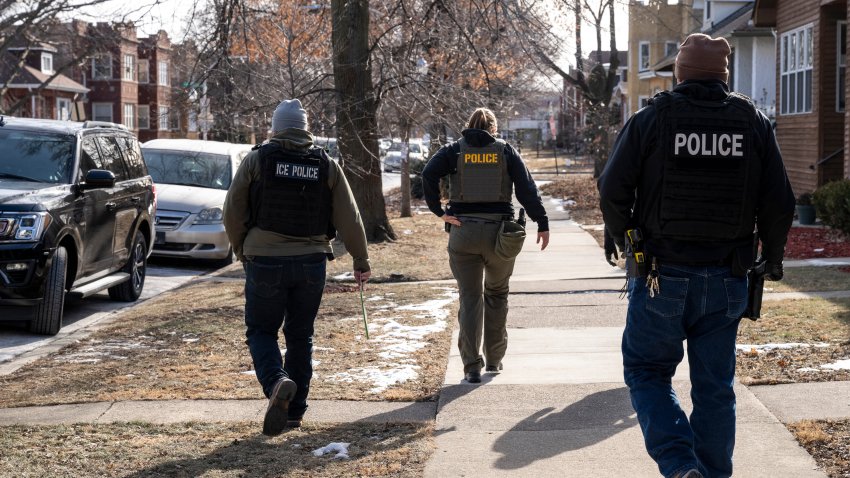 US Immigration and Customs Enforcement (ICE) agents walk down a street during a multi-agency targeted enforcement operation in Chicago, Illinois, US, on Sunday, Jan. 26, 2025. President Donald Trump has pledged to carry out the largest deportation effort in US history, vowing to ultimately deport all of the foreigners living in the country without permission. Photographer: Christopher Dilts/Bloomberg via Getty Images