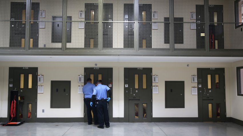 ADELANTO, CA – NOVEMBER 15: Guards prepare to escort an immigrant detainee from his ‘segregation cell’ back into the general population at the Adelanto Detention Facility on November 15, 2013 in Adelanto, California. Most detainees in segregation cells are sent there for fighting with other immigrants, according to guards. The facility, the largest and newest Immigration and Customs Enforcement (ICE), detention center in California, houses an average of 1,100 immigrants in custody pending a decision in their immigration cases or awaiting deportation. The average stay for a detainee is 29 days. The facility is managed by the private GEO Group. ICE detains an average of 33,000 undocumented immigrants in more than 400 facilities nationwide. (Photo by John Moore/Getty Images)