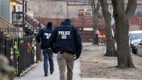 US Immigration and Customs Enforcement (ICE) agents walk down a street during a multi-agency targeted enforcement operation in Chicago, Illinois, US, on Sunday, Jan. 26, 2025. President Donald Trump has pledged to carry out the largest deportation effort in US history, vowing to ultimately deport all of the foreigners living in the country without permission. Photographer: Christopher Dilts/Bloomberg via Getty Images