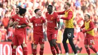 Liverpool’s players celebrate on the final whistle in the English Premier League football match between Liverpool and Tottenham Hotspur at Anfield in Liverpool, north west England on April 27, 2025. Liverpool were crowned English champions for a record-equalling 20th time as a 5-1 rout of Tottenham on Sunday sealed their first Premier League title since 2020. (Photo by Paul ELLIS / AFP) / RESTRICTED TO EDITORIAL USE. No use with unauthorized audio, video, data, fixture lists, club/league logos or ‘live’ services. Online in-match use limited to 120 images. An additional 40 images may be used in extra time. No video emulation. Social media in-match use limited to 120 images. An additional 40 images may be used in extra time. No use in betting publications, games or single club/league/player publications. /  (Photo by PAUL ELLIS/AFP via Getty Images)