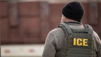 A US Immigration and Customs Enforcement (ICE) agent stands on a street during a multi-agency targeted enforcement operation in Chicago, Illinois, US, on Sunday, Jan. 26, 2025. President Donald Trump has pledged to carry out the largest deportation effort in US history, vowing to ultimately deport all of the foreigners living in the country without permission. Photographer: Christopher Dilts/Bloomberg via Getty Images