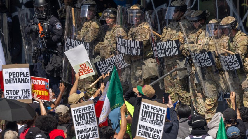 LOS ANGELES, CALIFORNIA – JUNE 09: A police officer holds a nonlethal rifle as protesters confront California National Guard soldiers and police outside of a federal building as protests continue in Los Angeles following three days of clashes with police after a series of immigration raids on June 09, 2025 in Los Angeles, California. Tensions in the city remain high after the Trump administration called in the National Guard against the wishes of city leaders.  (Photo by David McNew/Getty Images)