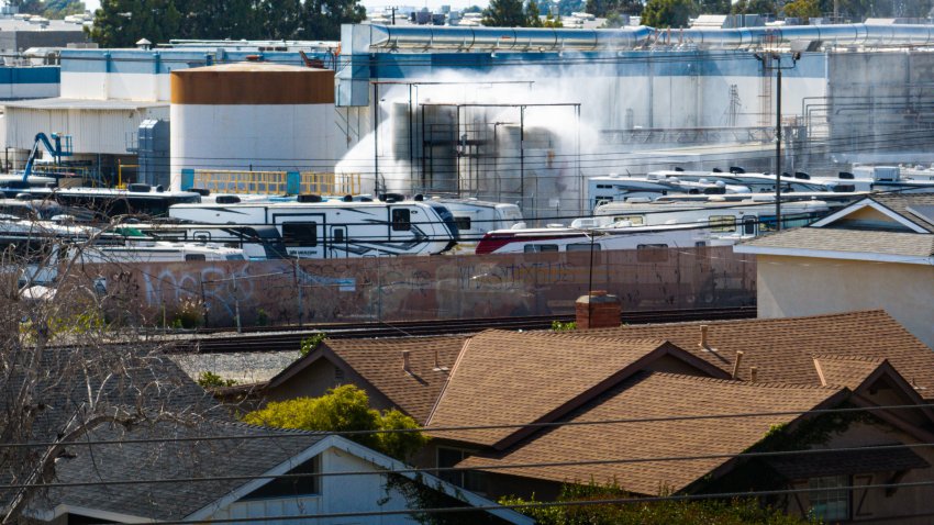 An aerial of water being sprayed on large storage tanks at the GKN Aerospace facility on Sunday, May 24, 2026.