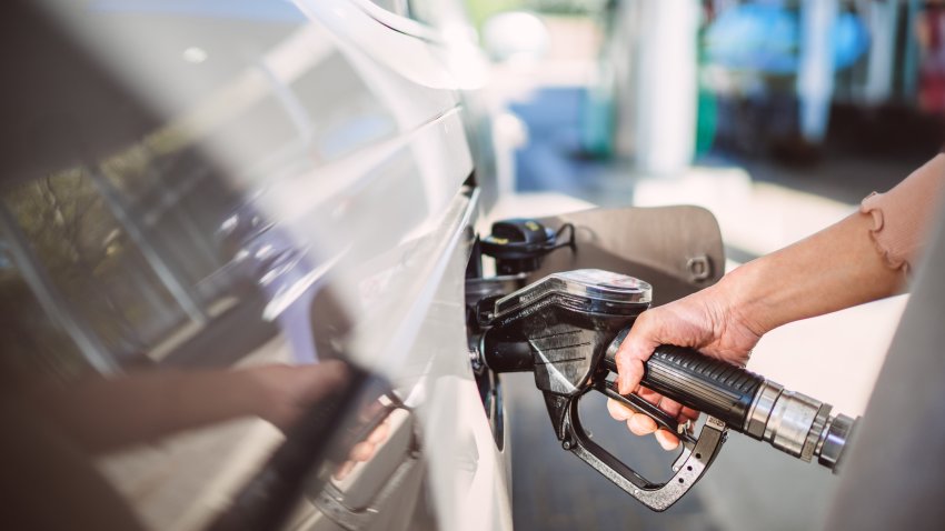 Close-up of a woman’s hand holding a diesel fuel pump while refuelling a car at a gas station. Ideal for themes related to automotive maintenance, fuel efficiency, and sustainable transport solutions.
